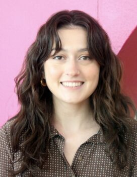 Portrait of the smiling designer with a pink background