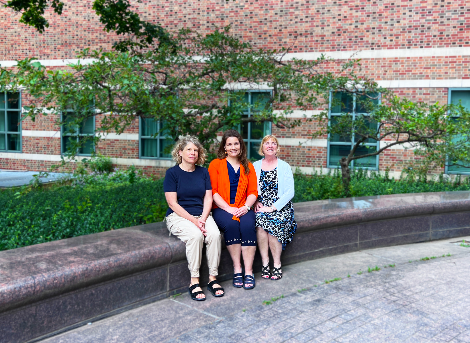 photo of Stephanie Ceman, Laura Hetrick, and Tracey Wszalek sitting outside Beckman