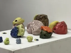 Colorful ceramic forms on a pedestal. 