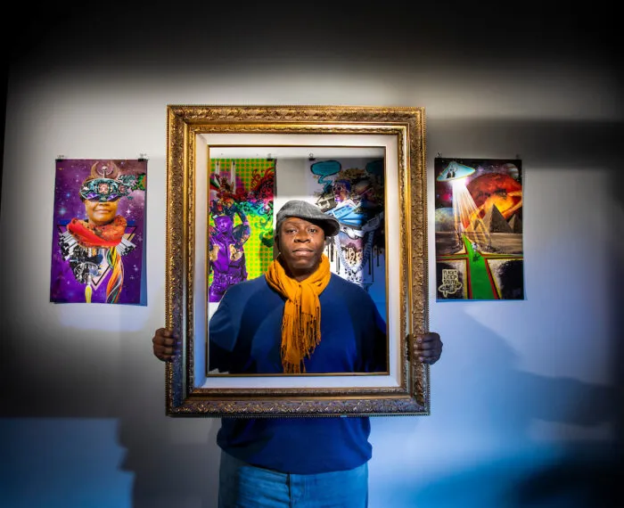 person holding frame in front of their face