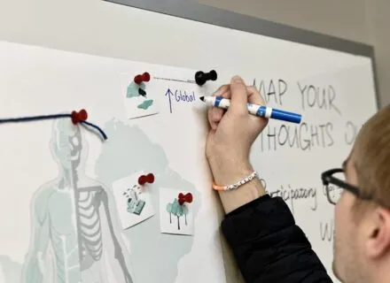 person drawing on map