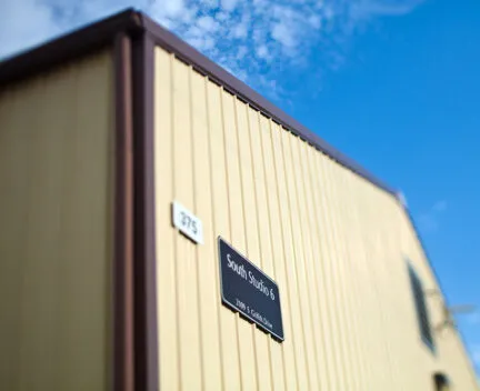 photo of building with yellow siding and name placard that says south studio 6