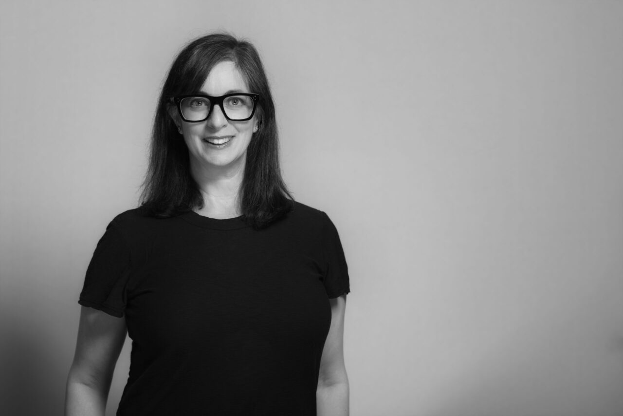 black and white portrait of someone wearing black t-shirt and glasses