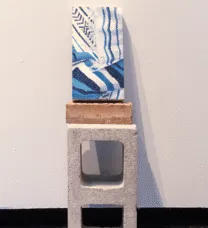 sculpture with cinder block at bottom