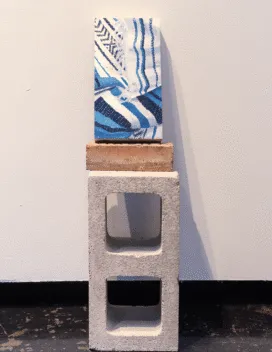 sculpture with cinder block at bottom