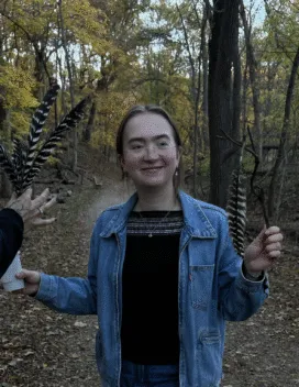 young woman with glasses and blue jacket