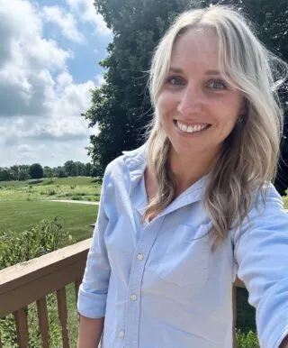 victoria austen smiling at camera with light blue shirt