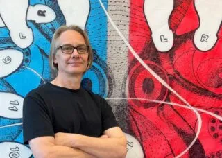 Ron Laboray in front of his work