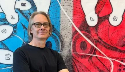 Ron Laboray in front of his work