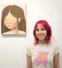 young woman next to a painting