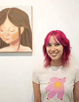 young woman next to a painting