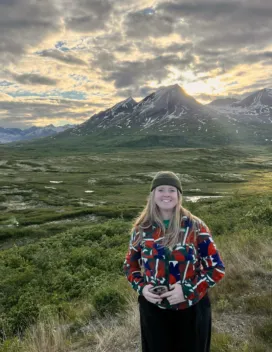 young woman in front of mountain