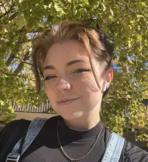 young person in front of trees