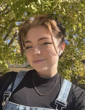 young person in front of trees