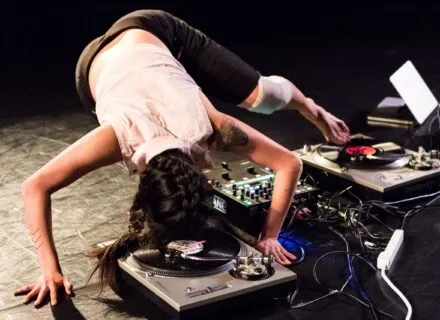 A dancer hovers over a turn table
