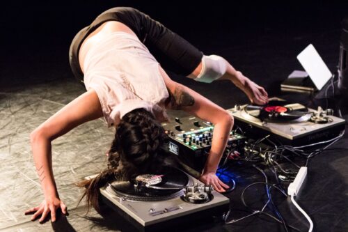 A dancer hovers over a turn table