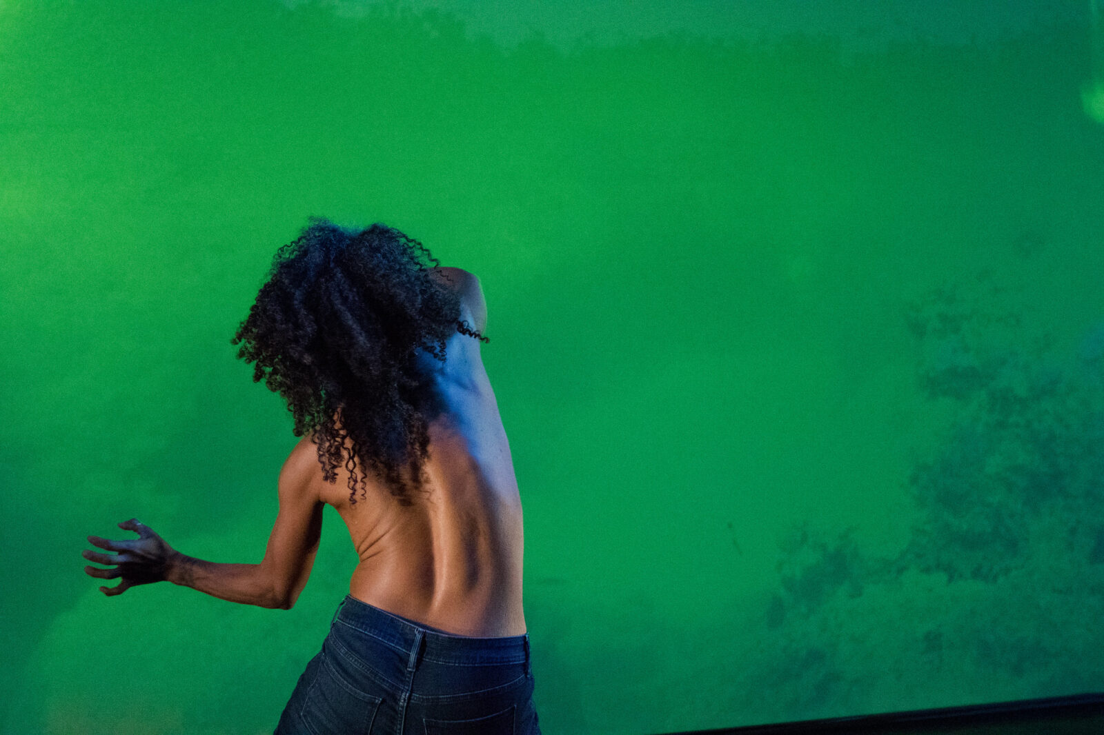 Dancer's bare back against a green screen