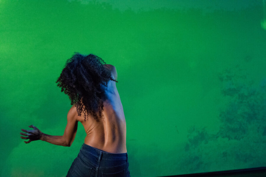 Dancer's bare back against a green screen