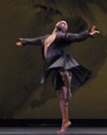 Joe dances with his arms outstretched beside him
