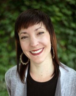 A headshot of Laura smiling 