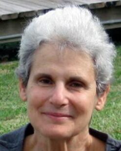 A headshot of Pat, smiling