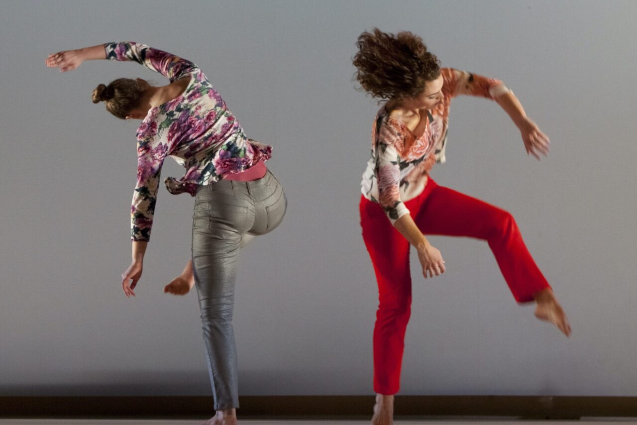 two dancers in motion away from each other