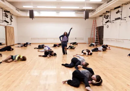 solo dancers stands tall amongst dancers on the floor