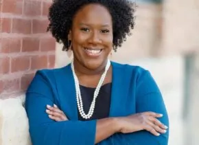 Headshot of Mariam with arms crossed