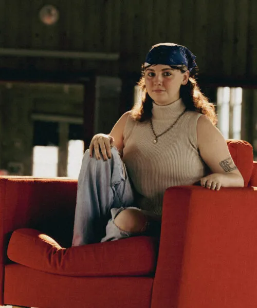 Marlee sits on a red chair