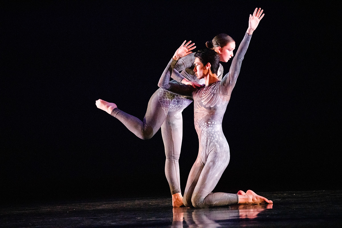 two people in leotards dance together onstage