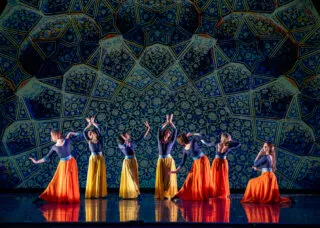 Dancers on stage with green background