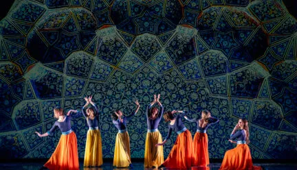 Dancers on stage with green background