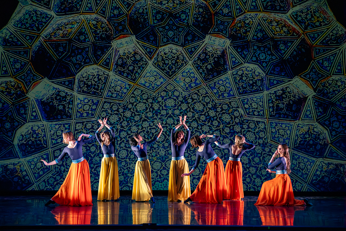 Dancers on stage with green background