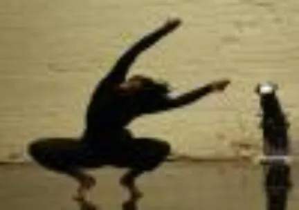 A dancer crouches down