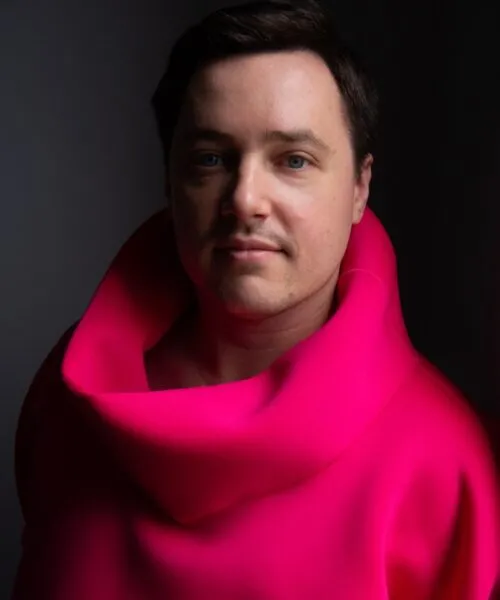 Jacob wearing a hot pink turtleneck