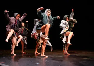 dancers onstage with legs up