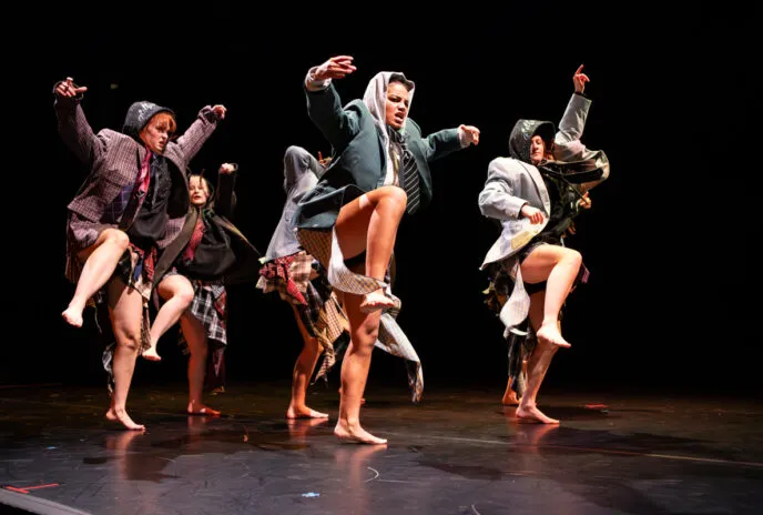 dancers onstage with legs up