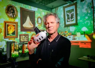 john toenjes holds a virtual reality headset