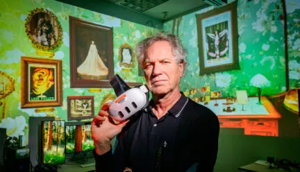 john toenjes holds a virtual reality headset