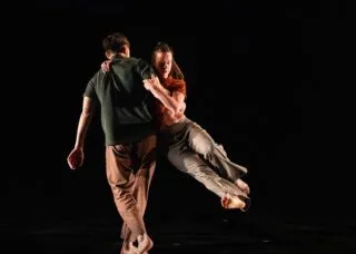 One dancers picks up another on his hip