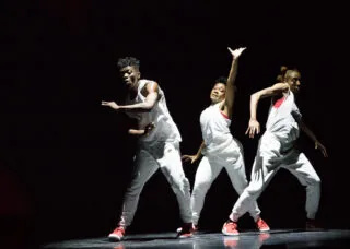Three dancers in the spotlight