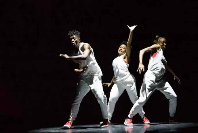 Three dancers in the spotlight