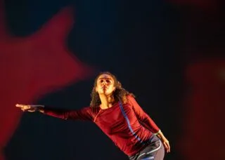 one dancer outstretches her arm