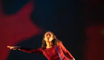 one dancer outstretches her arm