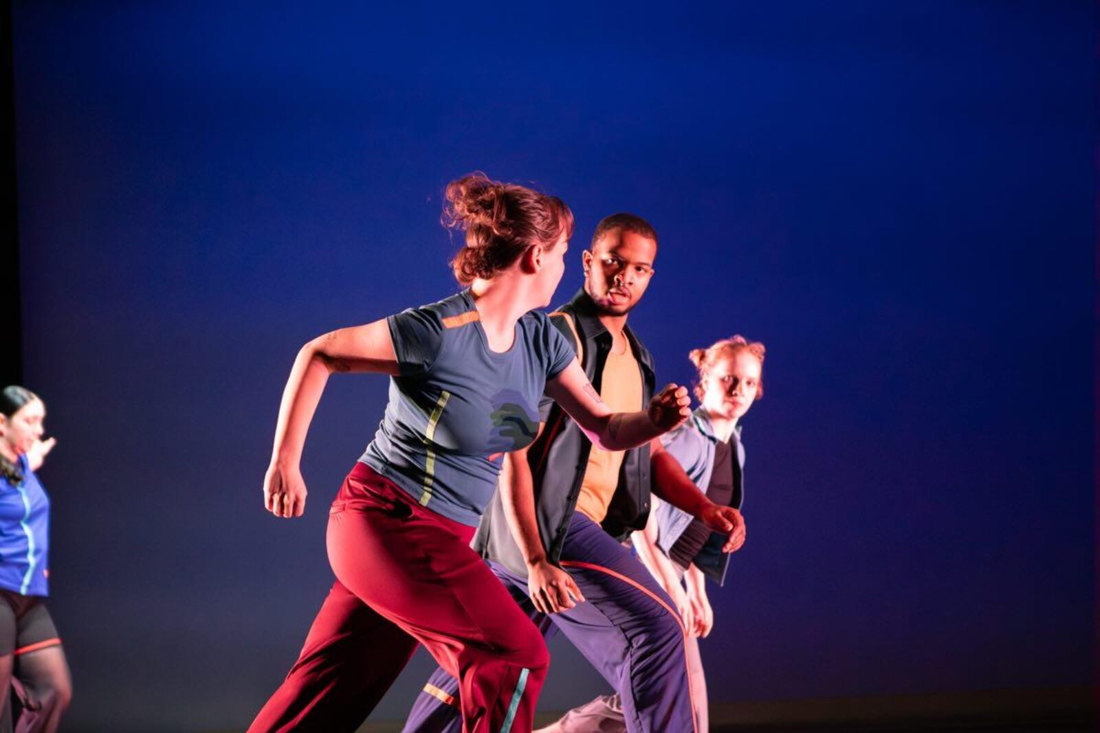 A trio of dancers move through the air
