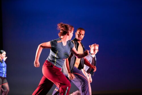 A trio of dancers move through the air