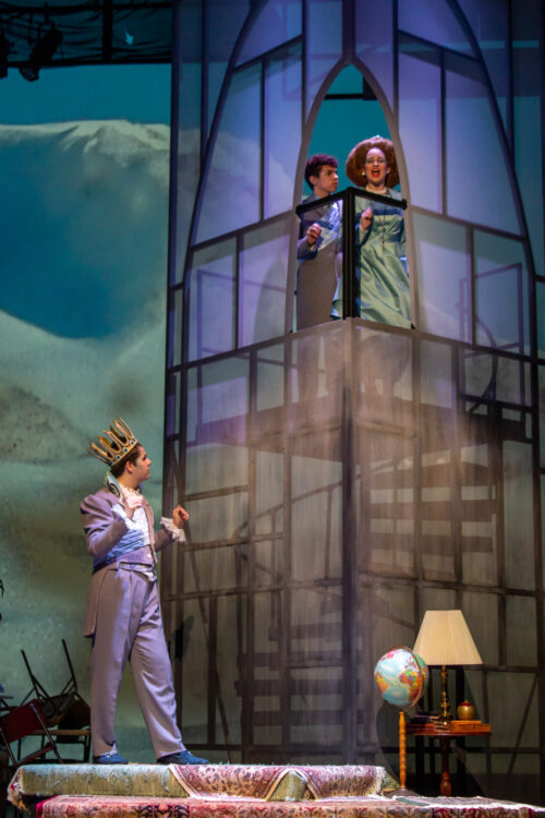 Actors onstage during production with tower made of transparent fabric