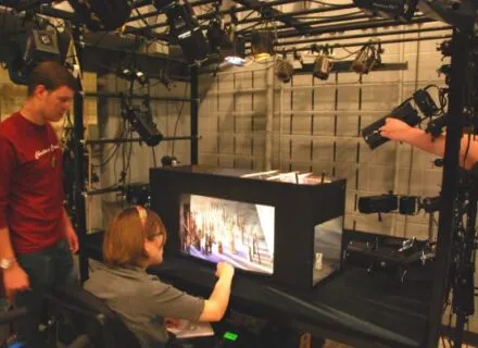 Two students examine a lighting model in the light laboratory 