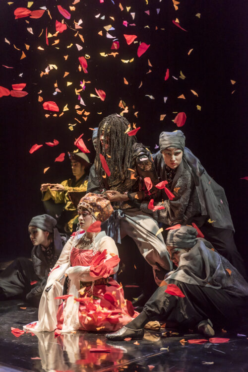 Petals fall on actors in theatre production