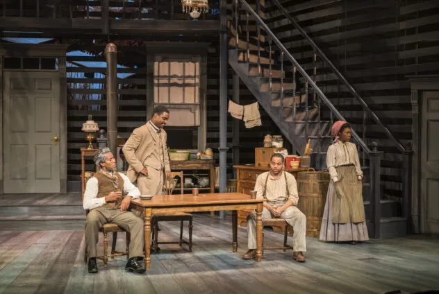 People sitting around table on stage